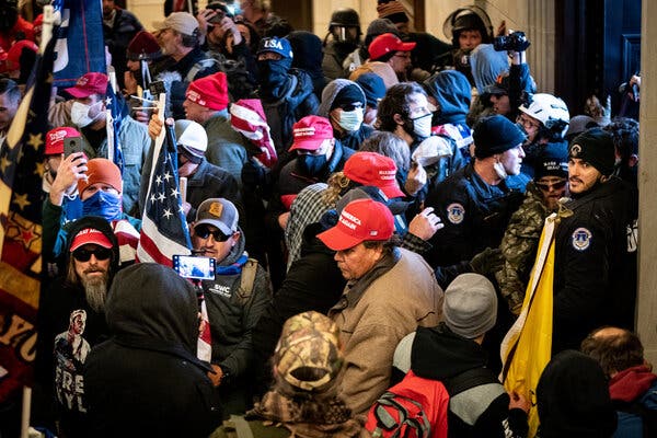 Rioters at the Capitol on Jan. 6 wore red hats and carried flags bearing President Donald Trump’s campaign slogan, “Make America Great Again.”